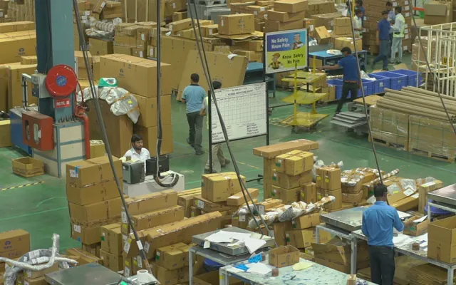 Warehouse team sorting and packing cartons